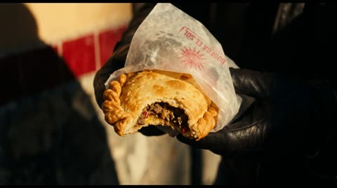 Empanada in grease paper
