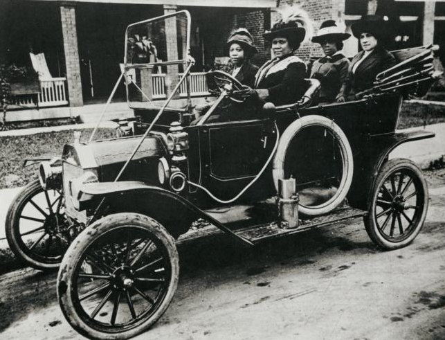 Madam C. J. Walker at the wheel of a car with three women passengers, 1911